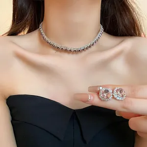 Close-up detail of luxury sparkling crystal necklace and stud earrings on model