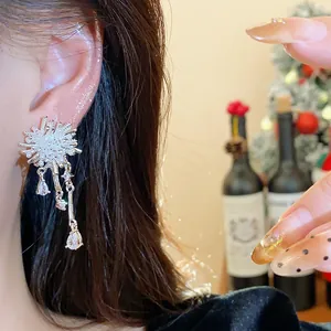 Close-up detail of elegant silver firework drop earrings with sparkling zircons worn by model