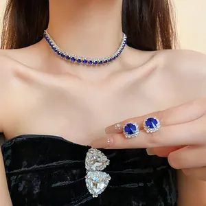 Elegant detail showing blue gemstone necklace and earrings set with rhinestones