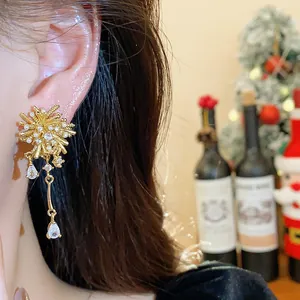Elegant close-up of 18k gold plated zircon fireworks earrings with a teardrop drop pendant