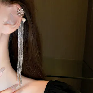 Detailed view of long tassel ear cuff with elegant pearls and sparkling rhinestones.