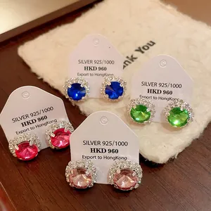 Close-up of square crystal stud earrings in multiple colors on white display cards