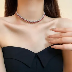 Detailed close-up view of an elegant silver-toned necklace with pink crystal row on a model.
