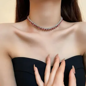 Detailed view of elegant silver choker necklace with square red gemstones worn by a model