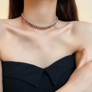 Detail view of an elegant silver clavicle chain featuring radiant red square gemstones