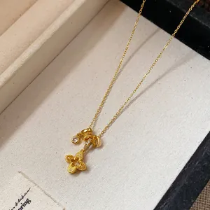 Detail of gold-plated flower pendant necklace with zircon stones in a jewelry box