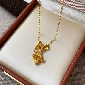 Detailed view of elegant gold-plated flower and zircon pendants on a vintage necklace.