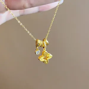 Detailed close-up of a gold plated flower pendant necklace with zircon stone charms