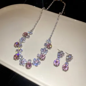 Close-up of pink and white zircon flower jewelry set with necklace and earrings.