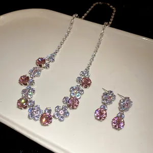 Detailed view of luxury pink zircon floral necklace and earrings jewelry set.
