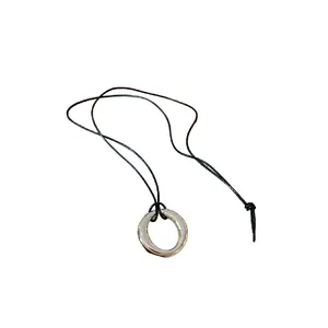 Collier minimaliste en cordon de cuir noir doté d'un pendentif circulaire en métal