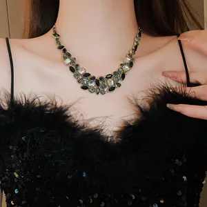 Gros plan d'un collier plastron chic avec des pierres noires et grises sur un mannequin