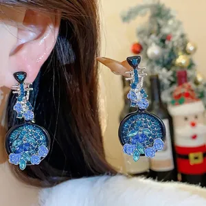 Elegant vintage lute-shaped earrings featuring blue rhinestones and intricate flower details