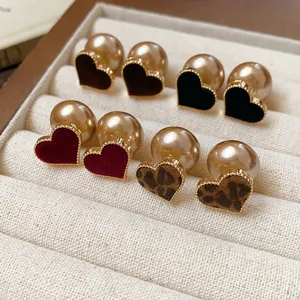 Collection of heart earrings with flocked red, black, and leopard textures and pearl backs