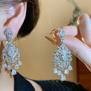 Close-up of French vintage cubic zirconia teardrop earrings with elegant pear stones.