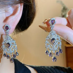 Detailed close-up view of vintage French court style silver zircon waterdrop dangle earrings.