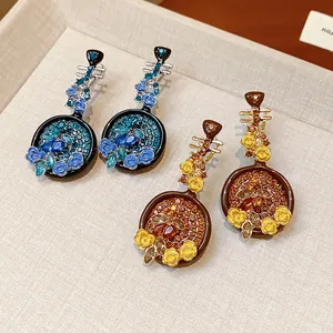 Detailed macro shot of vintage Pipa-shaped earrings with rhinestones and flowers