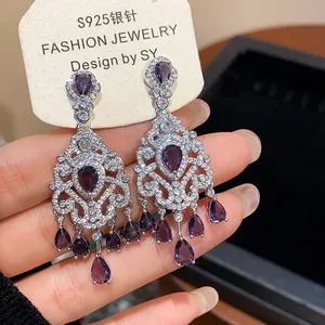 Close-up detail of French vintage court style earrings with purple teardrop zircons