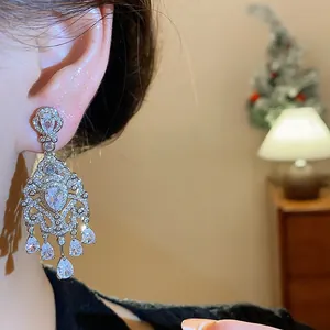 Close-up of French vintage palace style earrings with sparkling zircon waterdrops