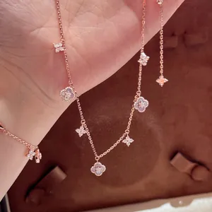 Close-up of rose gold bracelet featuring sparkling zircon and iridescent mother-of-pearl flower motifs