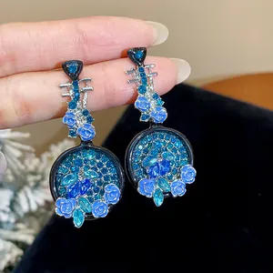 Exquisite detailed view of pipa-shaped earrings featuring blue roses and blue crystals