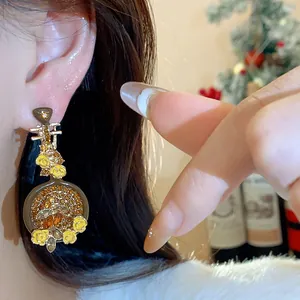 Detail shot of elegant Pipa earrings featuring sparkling rhinestones and yellow flowers