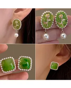 Detailed views of vintage green rose earrings and square pearl studs shown on ear