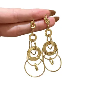 Elegant golden dangling earrings with multi-layered ruffled hollow circles.