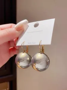 Close-up of elegant grey sphere earrings with S925 silver posts on a display card