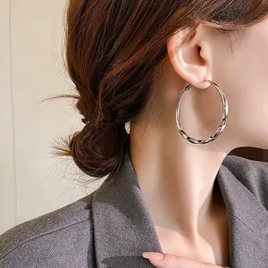 Elegant silver twisted hoop earrings for women with high-end minimalist design