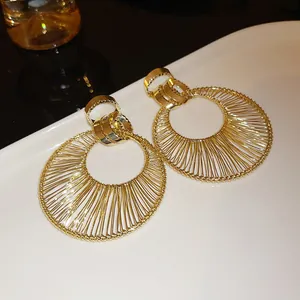 Gold wire wrapped circular drop earrings with interlocking top rings luxury jewelry