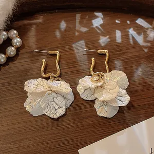 Exquisite close-up of French retro shell petal earrings with geometric gold hoops