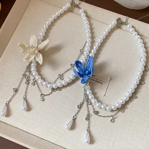 Detail of beaded flower necklaces with teardrop pearls and delicate silver chains