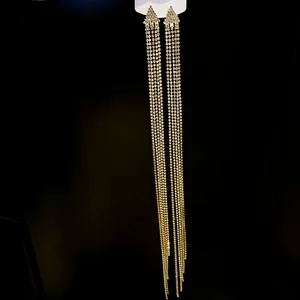 Macro detail of elegant long tassel earrings featuring shimmering silver needle rhinestones