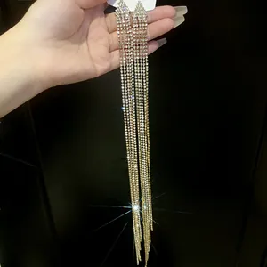 Close-up detail of silver long tassel earrings with shimmering rhinestone accents