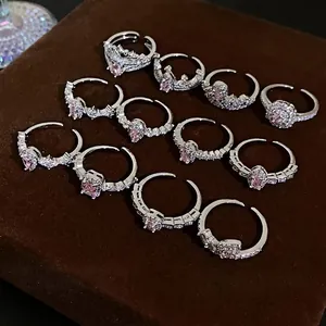 Collection of stylish silver-colored zircon open rings with pink stones for fashion women