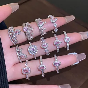 Elegant silver-tone zircon rings with pink gemstones displayed on fingers for women.