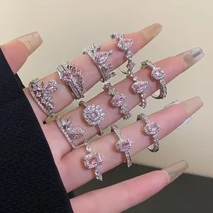Collection of elegant silver-colored rings with pink zirconia stones for women on hand