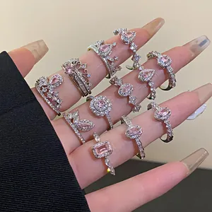 Detailed close-up view of silver-colored rings featuring sparkling pink zircon stones.