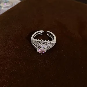 Close-up of elegant silver adjustable crown ring with pink zircon and pavé stones