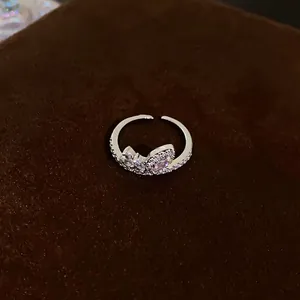 Detail view of a silver geometric open ring set with sparkling cubic zirconia stones