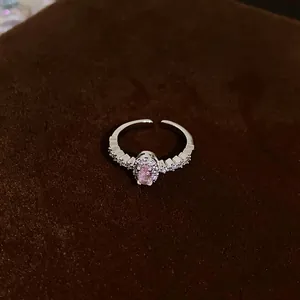 Close-up of an elegant silver adjustable ring featuring a pink oval zirconia stone.