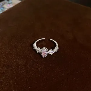 Elegant silver-colored open ring featuring a pink teardrop zircon and clear crystal accents.