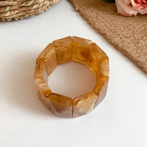 Detail of vintage amber marbled acrylic rectangular elastic bracelet