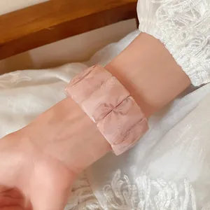 Detailed close-up of pink marbled acrylic rectangular stretch bracelet worn on wrist