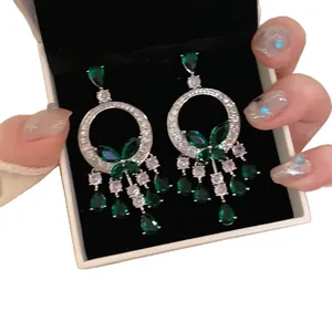 Luxury green crystal butterfly tassel earrings with elegant silver needle drop design.