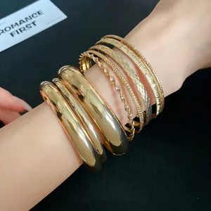 Elegant set of gold-plated geometric textured bangles for a layered fashion look