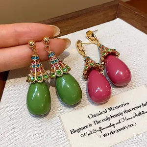 Macro view of vintage resin teardrop earrings with colorful rhinestone details
