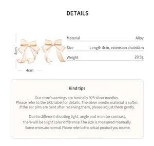 Detailed view of elegant cream enamel bow earrings featuring silver needle parameters