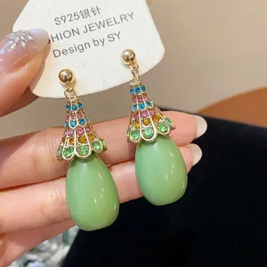 Close-up of vintage resin teardrop earrings with multi-colored rhinestones and S925 needle